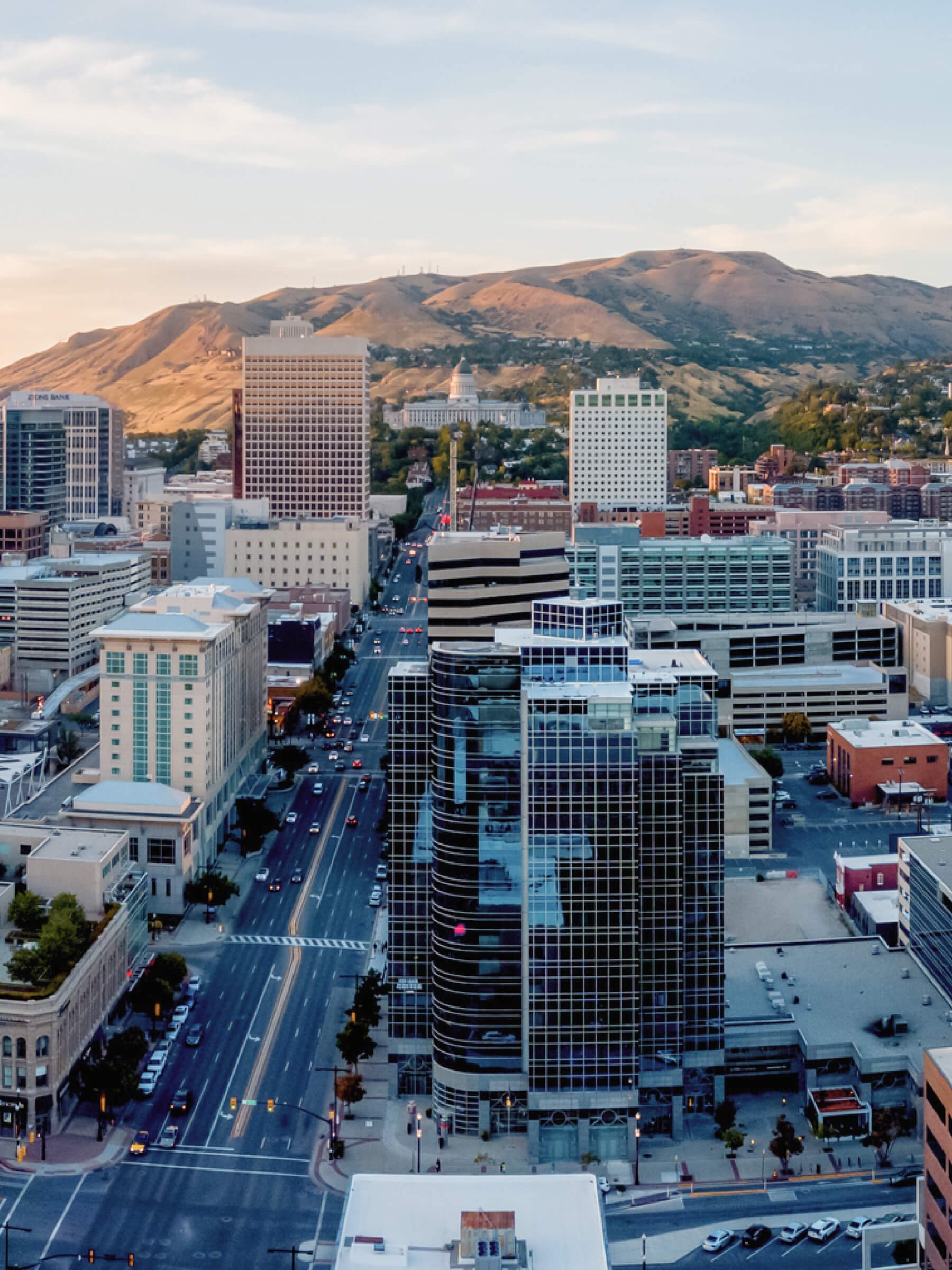 Aerial view of a Salt Lake City Utah skyline and mountains in the background during daytime.